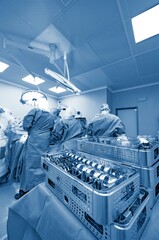 In a high-tech operating room, a robotic surgical device assists in total knee replacement. The advanced technology enables precise bone resections and enhances surgical outcomes