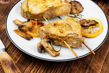 Grilled tuna steak with roasted mushrooms.