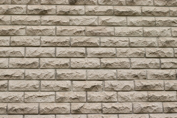 Fototapeta premium Light decorative stone brick wall. Modern architectural background