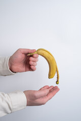 Man holding a banana. Concept: Men's health, prostate prevention, healthy eating, and vitamins.