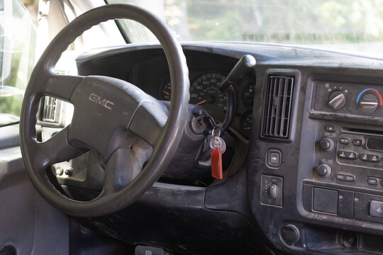 Canada, 08 September 2025 : GMC steering wheel dusty dashboard car keys ignition inside parked vehicle