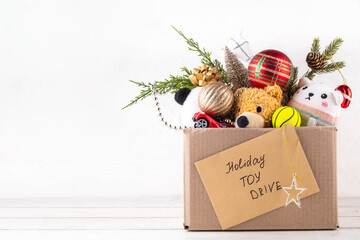 Tradition holiday toys drive, cardboard box full with with kids toys and gifts