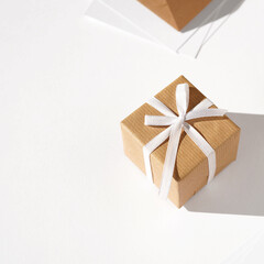 Present. Holidays Gift Wrapped in Kraft Paper, Tied with White Ribbon Bow. Christmas, New Year.	         