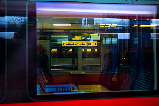 chur, graubuenden, switzerland - 26 10 2025: a postbus station sign seen through a swiss train