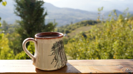 Handmade Ceramic Mug of Coffee Against a Sunny View