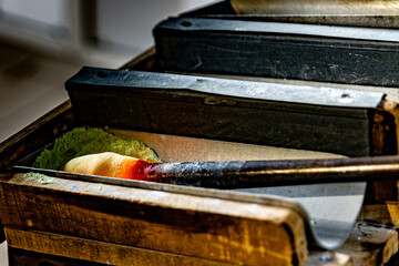 Glassblowing tools and molten glass in artisan workshop