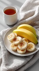 Top Down View Of Sliced Bananas With Whole Bananas And A Cup Of Tea On A Table