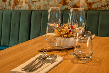 Elegant restaurant table setup with wine glasses and floral centerpiece
