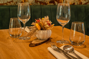 Elegant restaurant table setup with wine glasses and floral centerpiece
