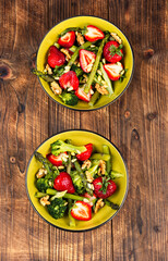 Salad of green asparagus, strawberries and pine nuts.