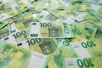 Full frame Wide Shot of Scattered One Hundred Euro Banknotes Cash Currency Pile Filling the Frame with Depth of Field
