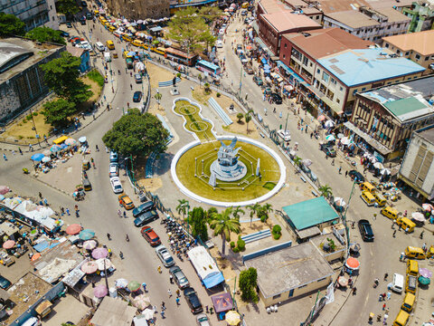 Aerial view of the vibrant roundabout monument surrounded by bustling traffic and colorful buildings, a symphony of urban life, Lagos, Lagos, Nigeria.