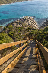 Long, steep wooden stairs leading to beautiful rocky shoreline.  Observatory Beach, Esperance, Western Australia.