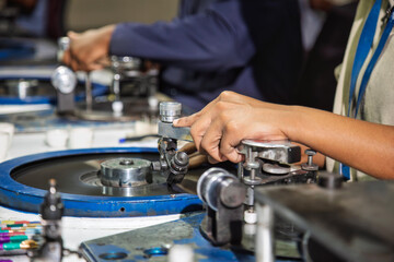 two african workers, diamond polisher at work, using a polishing wheel to shape and refine a rough diamond, brillianteering