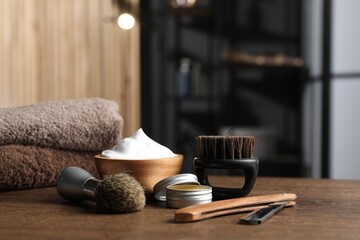 Barber's tools on wooden table in barbershop, closeup. Space for text