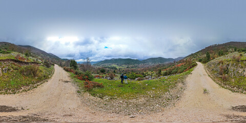 360 panorama of hikers in mountain valley landscape