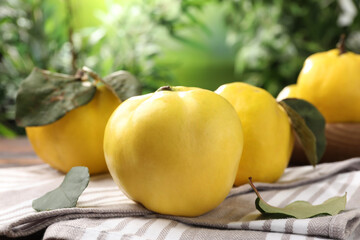 Fresh ripe quinces on table outdoors, closeup