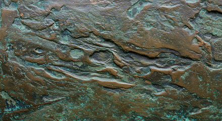 Oxidized and weathered copper metal surface with green patina