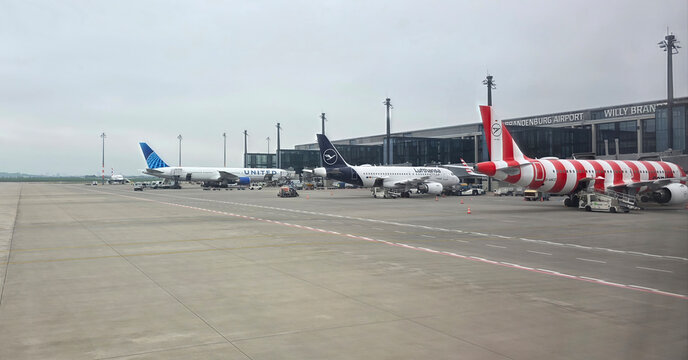 Airplanes parked at Willy Brandt Airport with terminal in background