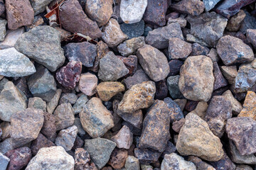 Macro top-down (flat lay) shot of gravel or crushed stones. The rocks create a perfect rough, natural background and texture.

