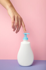 A hand liquid soap with pumping lotion from bottle. Hygiene woman wash hands concept.