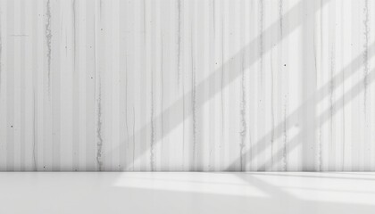 An interior space with high ceilings and white walls that give it an airy and minimalist feel. A concrete wall in the foreground suggests a contemporary architectural style