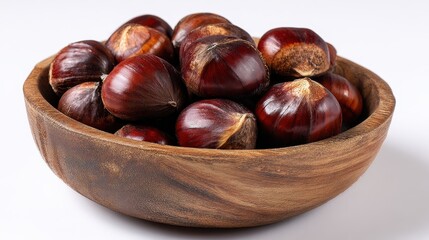 Obraz premium Freshly harvested chestnuts resting in a wooden bowl ready for cooking or roasting during autumn season