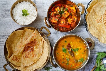 Indian vegetarian meal - Roti served with dal tadka paneer jalfrezi and rice