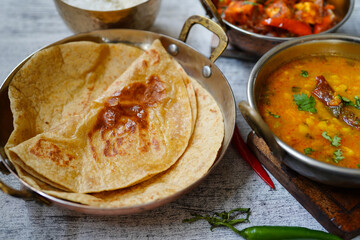 Indian vegetarian meal - Roti served with dal tadka paneer jalfrezi and rice