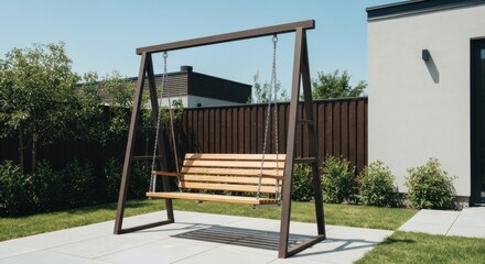 Swing on patio, sunlight. Backyard with fence & modern home backdrop