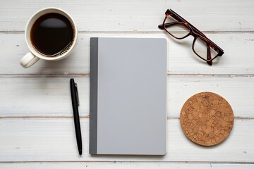 Workspace with coffee and notebook on white wooden table for writing and planning