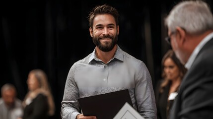A happy and smiling man holding a certificate or award participates in a professional business recognition ceremony