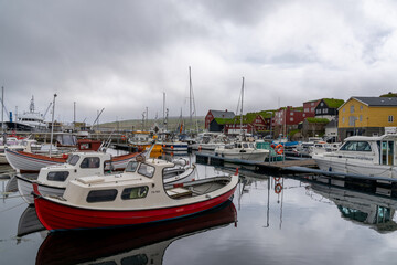Fototapeta premium downtown Torshavn with the colourful buildings of the Tinganes government district and many boats and ships in the harbour