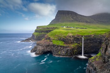 view of the famous Mulafossur Waterfall on Vagar Island in the Faroe Islands