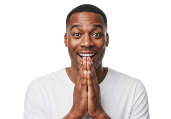 Man expressing joy and excitement with hands clasped together, smiling brightly in a simple white shirt