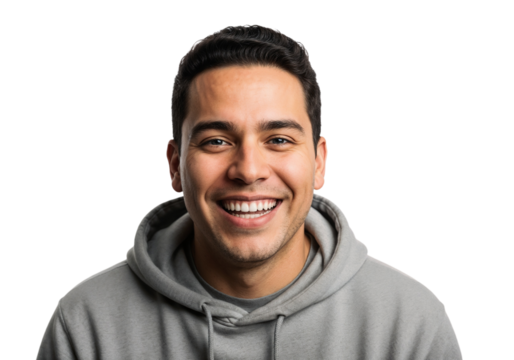 Smiling young man wearing a gray hoodie in a bright setting enjoys a cheerful moment