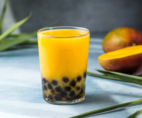 Mango smoothie with boba pearls, creamy mango lassi bubble tea, tropical summer drink