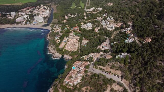 Scenic high altitude perspective of the Canyamel coast in Mallorca, turquoise water, sandy beaches, and luxury resorts nestled in coastline
