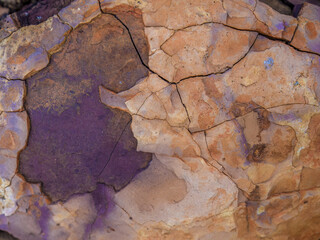 Fototapeta premium The texture and colors of a rock in the desert, macrophotography captured in La Candelaria desert, in the eastern Andean mountains of central Colombia, near the town of Raquira.