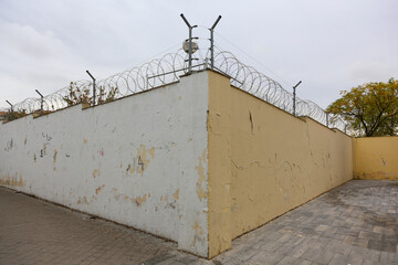 Texture of a brick wall with old, peeling paint in some partially ruined buildings