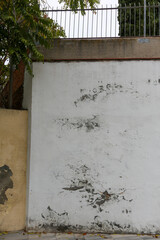 Texture of a brick wall with old, peeling paint in some partially ruined buildings