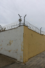 Texture of a brick wall with old, peeling paint in some partially ruined buildings