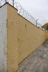 Texture of a brick wall with old, peeling paint in some partially ruined buildings