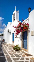 Naklejka premium Whitewashed church in a Greek village under a vibrant blue sky