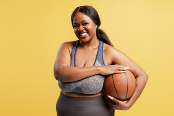 Plus size Black woman enjoying basketball sport