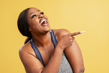 Black woman laughing loudly pointing finger