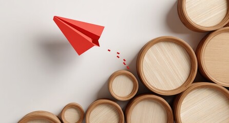 Red paper airplane soaring over stacked wooden circles