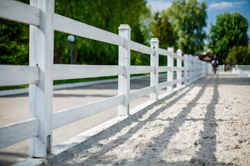 A typical American horse fence in the countryside. White fence.
