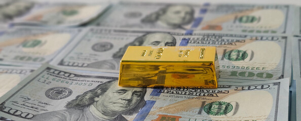 Gold bar and US dollars cash
