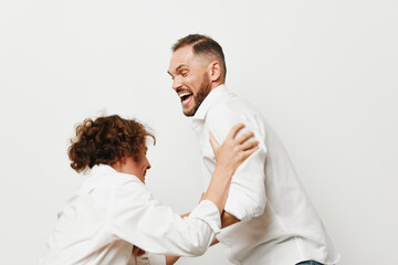 Obraz premium A professional man in business attire shares a joyful moment with a colleague against an isolated color background, expressing confidence, enthusiasm, and teamwork in a bright corporate setting.